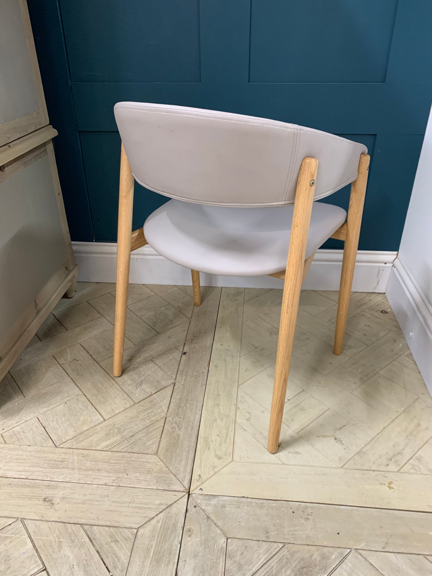 Blind Accessibility: "A rounded hospitality armchair made of solid beechwood with a comfortably padded, upholstered seat and back
