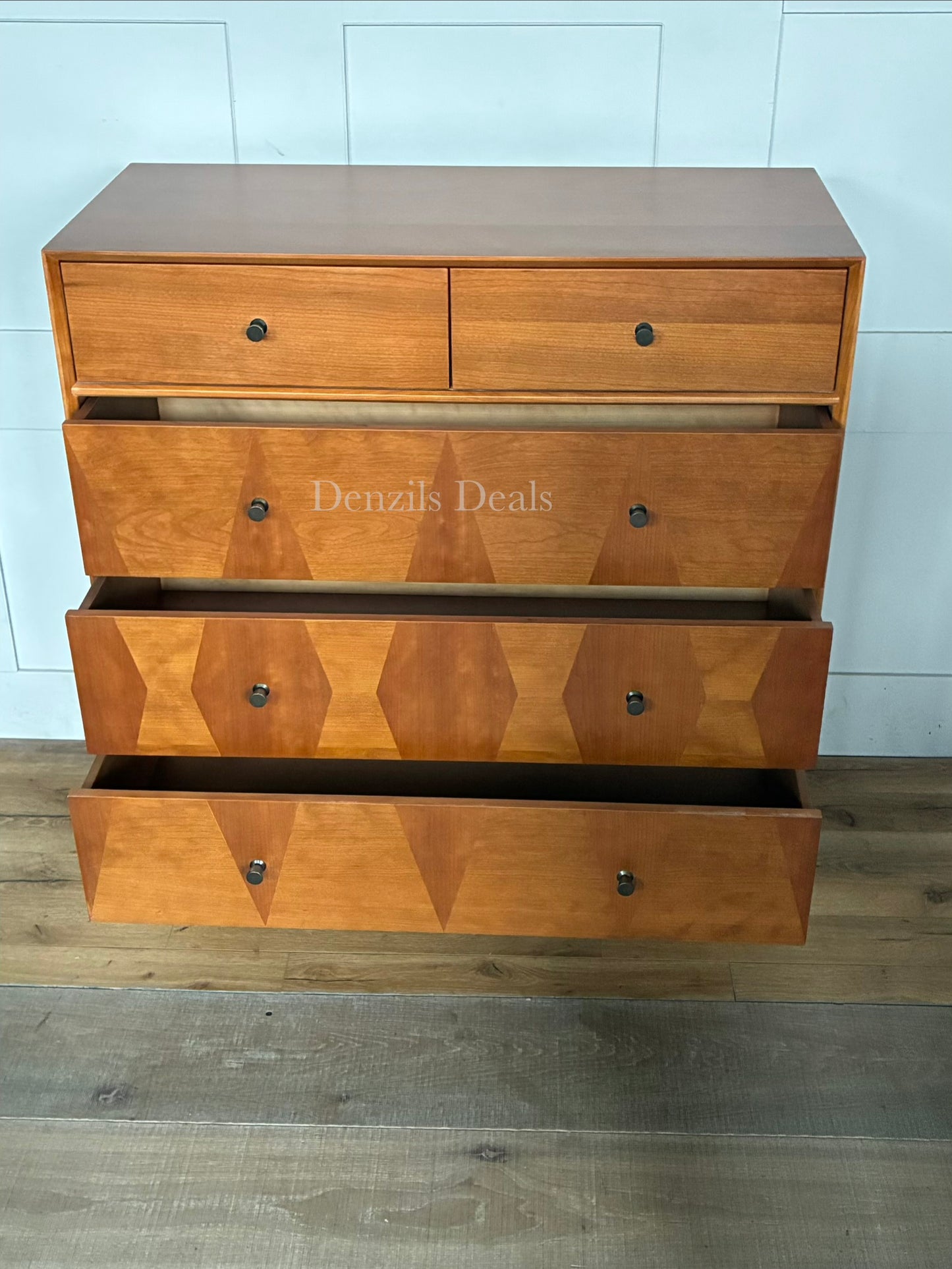 Front view of the John Lewis Marquetry 5-drawer wooden chest, showcasing the geometric woodwork detailing and slim legs.