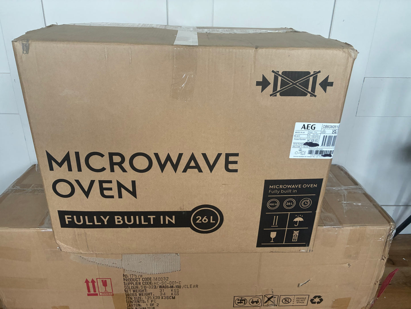 AEG OB6SM261UB 26L built-in solo microwave in gloss black with a touch-button door and digital LED display