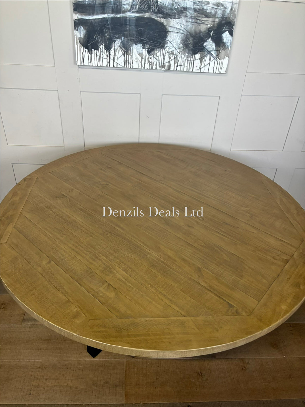 A 160cm round dining table featuring a natural pine tabletop with a visible wood patina and cross-shaped black metal legs.