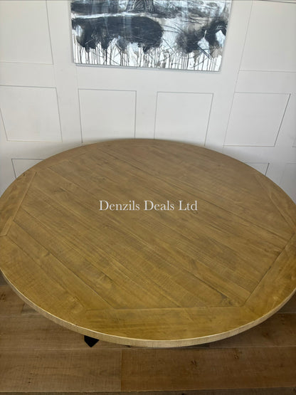 A 160cm round dining table featuring a natural pine tabletop with a visible wood patina and cross-shaped black metal legs.