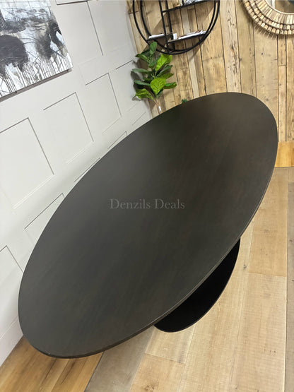 A large 250cm contemporary rectangular dining table by Richmond Interiors. The tabletop is crafted from oak and oak veneer with a dark coffee brown finish that subtly shows the natural wood grain. It is supported by a heavy-duty, modern black iron central pedestal base.