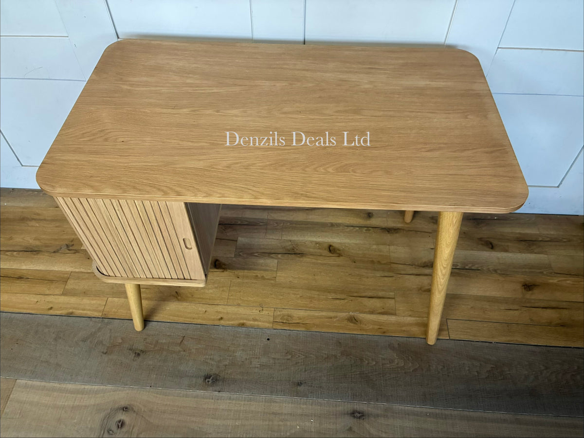 A John Lewis Grayson wooden bureau workstation with a closed slatted tambour cover. The unit features a compact, upright design with a top storage section, a slide-out desk surface, a lower drawer, and tapered legs in a Scandinavian style.
