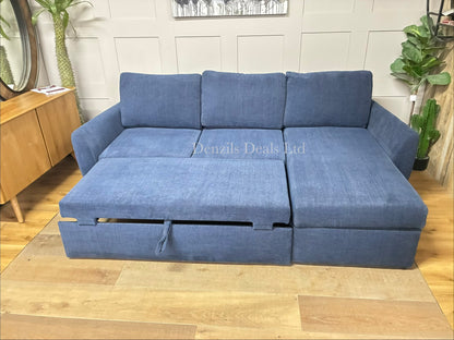 A John Lewis Sansa modular sofa bed with the hinged cushion of the chaise section lifted open, revealing a spacious, hidden built-in storage compartment underneath the seat.