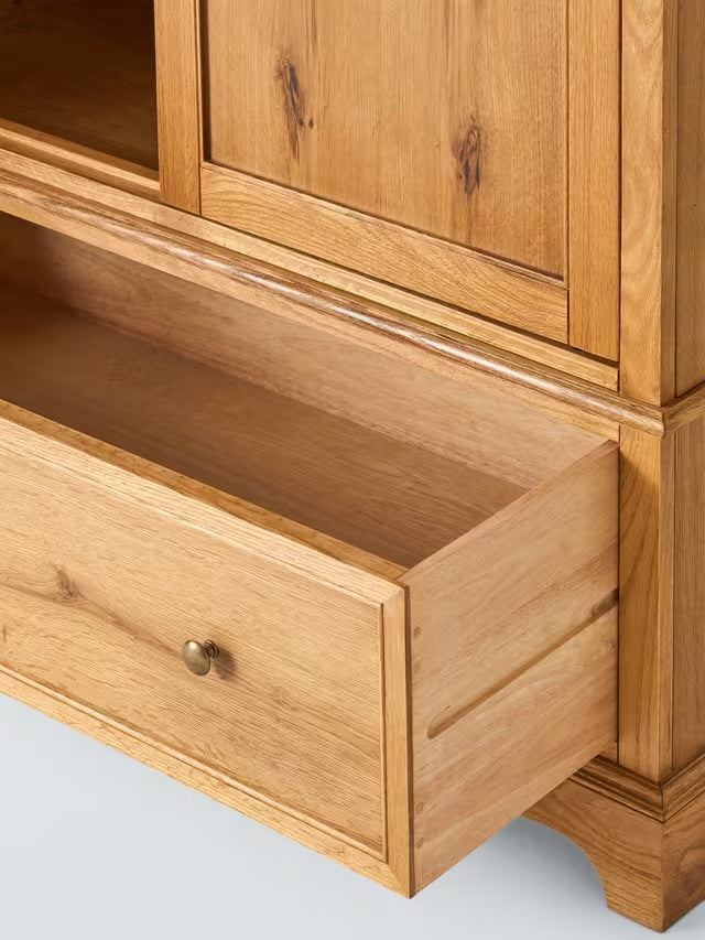 A classic John Lewis double-door wardrobe made from weathered oak, featuring an upper hanging compartment and a wide storage drawer at the base
