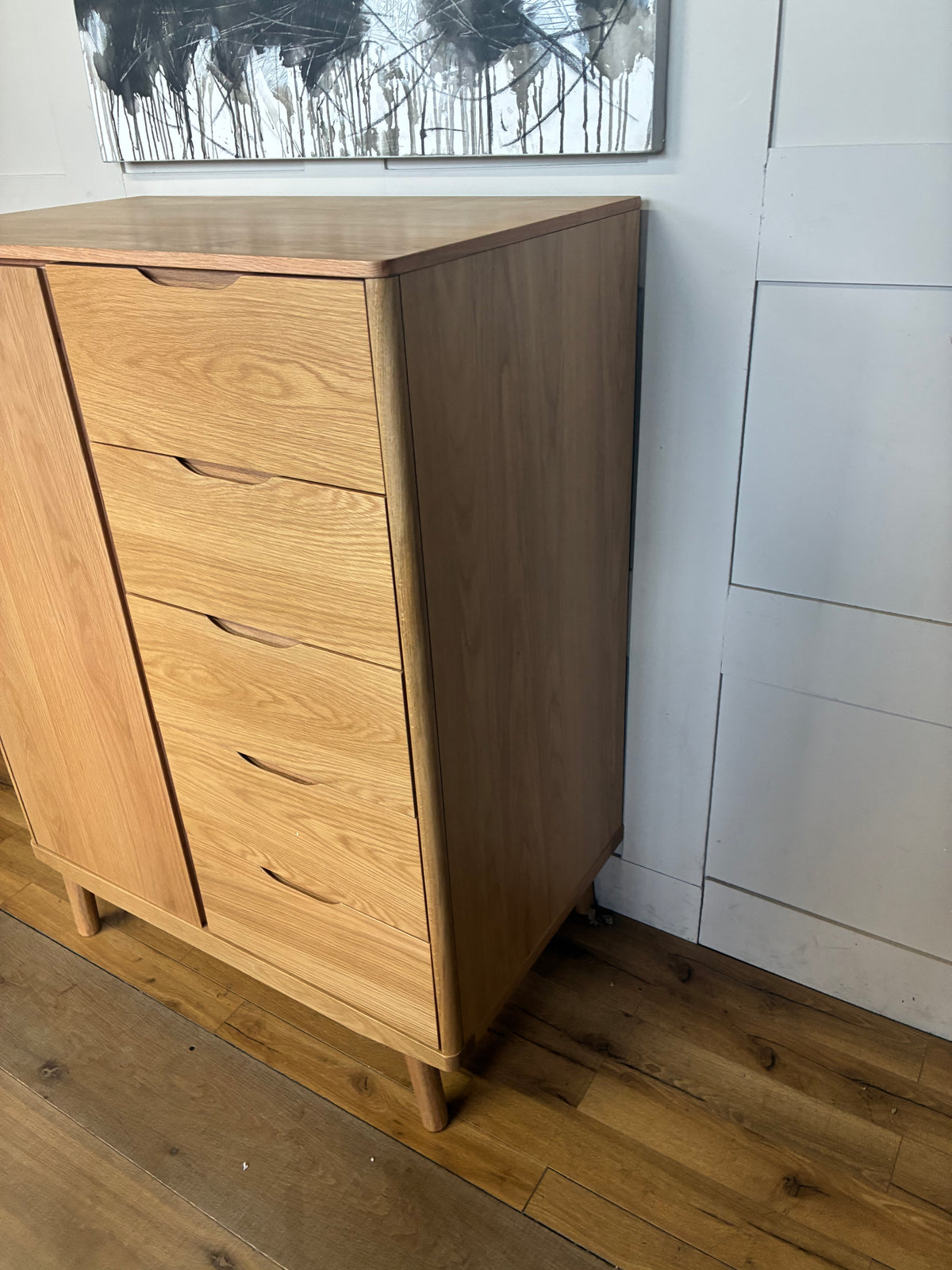 A compact natural solid oak and veneer low wardrobe from the John Lewis Bow range, featuring five integrated drawers, soft rounded edges, and splayed legs