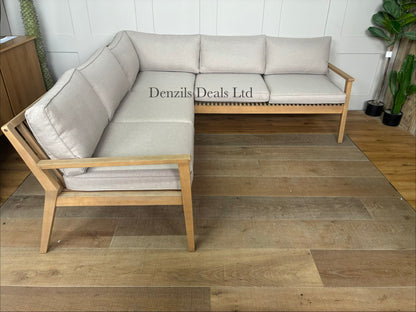 A contemporary John Lewis Mona 4-seater corner garden sofa made from natural-finish acacia wood with cream-coloured seat and back cushions.