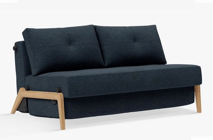 A contemporary two-seater sofa bed from Innovation Living upholstered in a textured, deep Nist Blue 515 fabric, featuring a compact space-saving design with minimalist legs and a clean, modern silhouette.