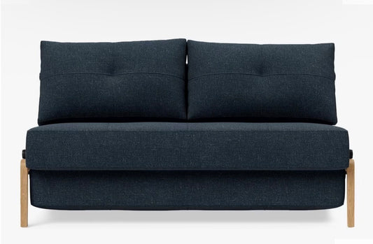 A contemporary two-seater sofa bed from Innovation Living upholstered in a textured, deep Nist Blue 515 fabric, featuring a compact space-saving design with minimalist legs and a clean, modern silhouette.