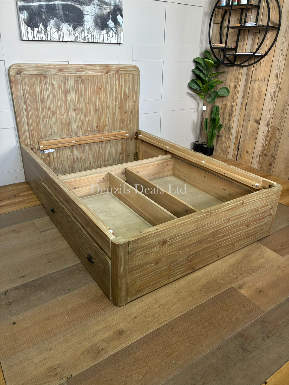 A cozy bedroom setting featuring the Loaf Woody solid wood double bed. The rustic, raw-textured eco-conscious fir frame is dressed in crisp white linens and neutral bedding, positioned against a soft-toned wall to highlight its natural, warm wood grain
