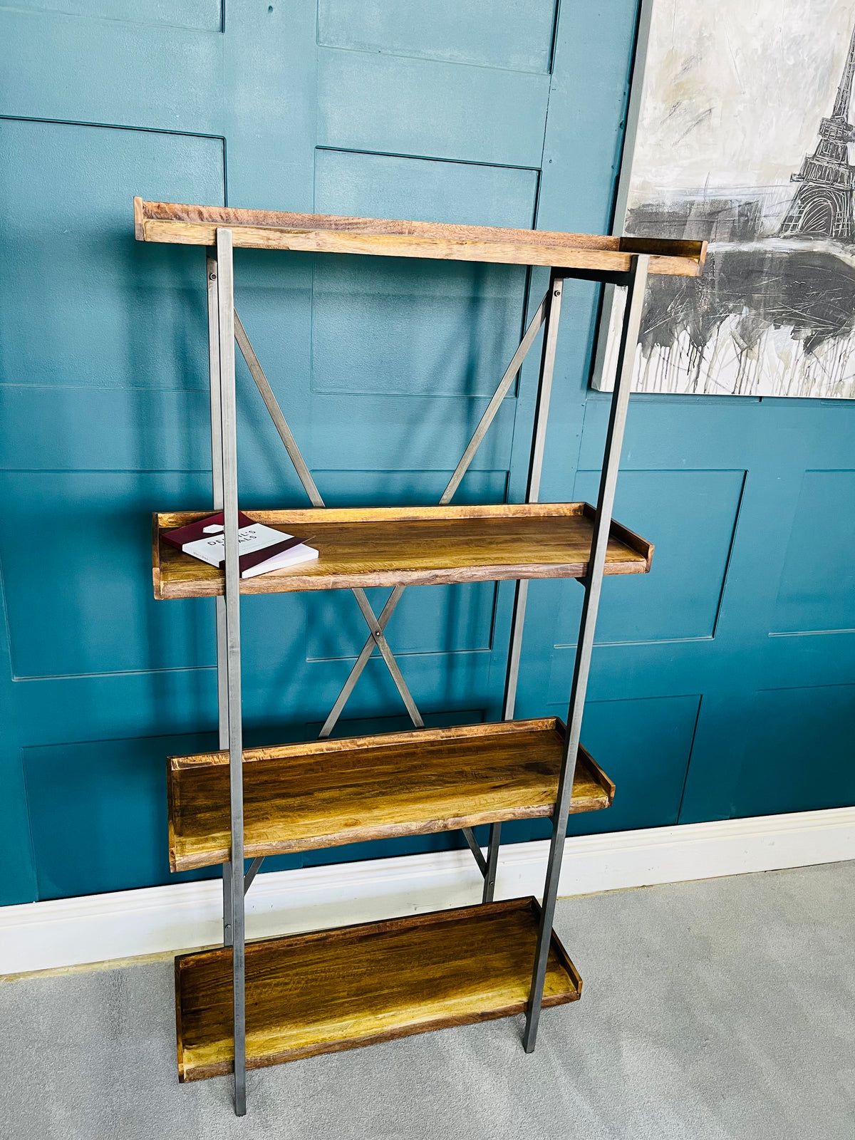 A four-tier tall wooden shelving unit with a natural light oak finish, featuring geometric open cubbies and a subtle live-edge design.