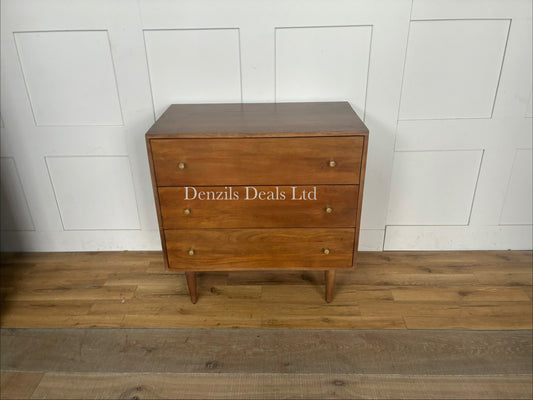 A handcrafted solid mango wood chest of three drawers in a rich walnut finish, featuring tapered legs, polished brass pull handles, and a clean Scandinavian minimalist design