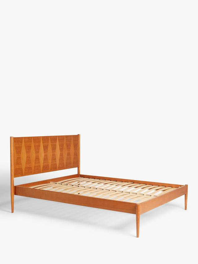 A king-size natural wood bed frame with a clean-lined headboard displaying a detailed geometric marquetry design. The frame features rounded corner posts, slender tapered legs, and contrasting wooden panels that highlight the natural grain patterns.