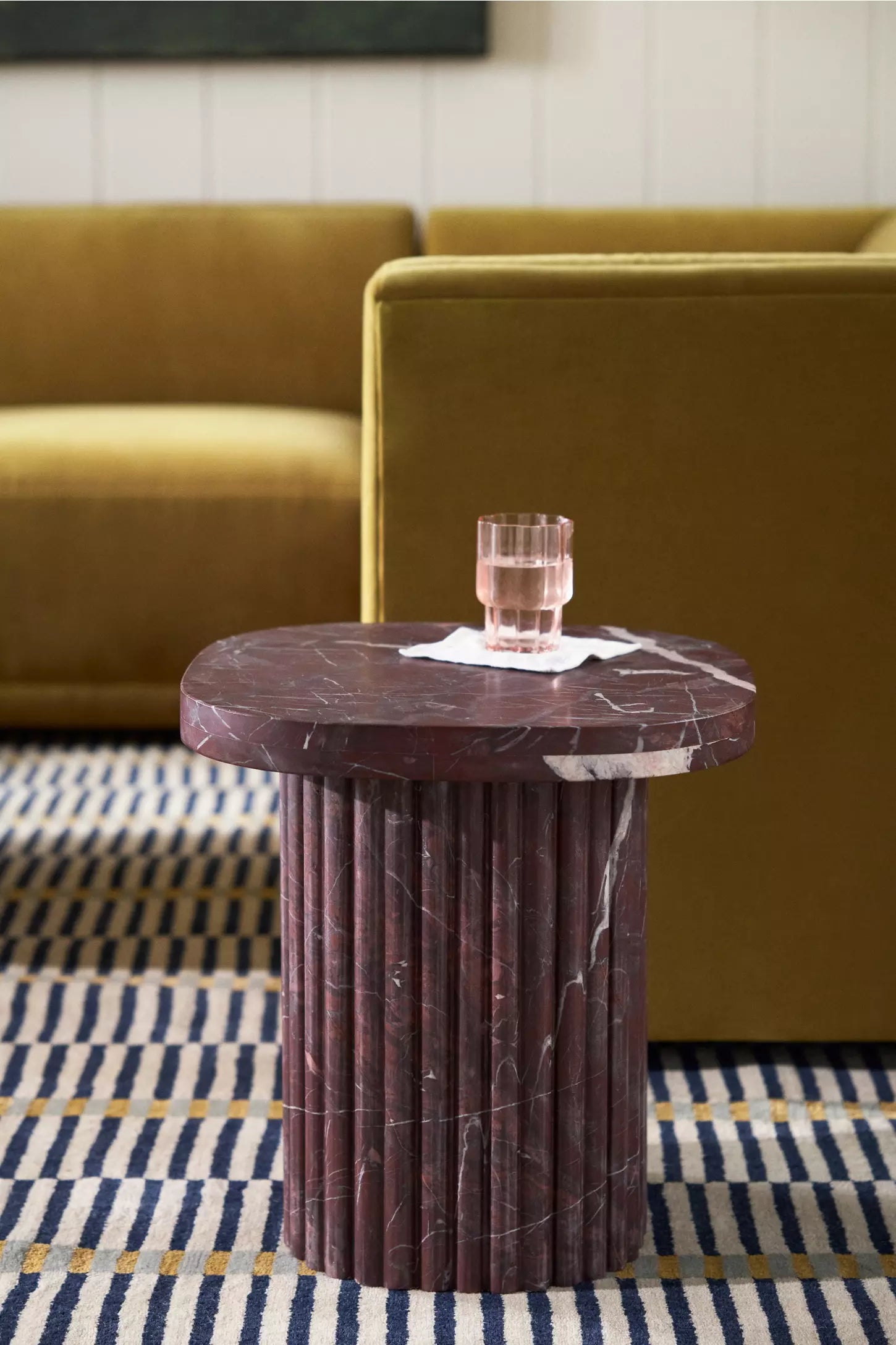 A luxurious 18-inch square side table crafted from solid, deep Merlot red marble. The flat, polished square tabletop showcases heavy cream and white natural veining. It rests centered upon a thick, round pedestal column base featuring a vertical fluted column design that mimics classic architecture."