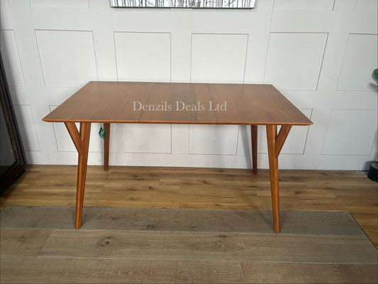 A mid-century modern rectangular wooden dining table in an acorn finish, featuring tapered A-frame legs and a clean-lined, streamlined top