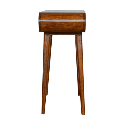 : A mid-century modern style console table made of solid mango wood with a rich chestnut finish, featuring a unique curved pill-shape top, two seamless drawers with small metallic knobs, and four tapered wooden legs.