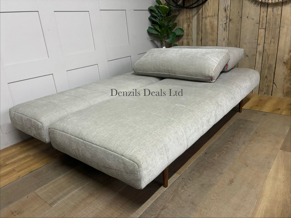 A minimalist Innovation Living Ripple sofa bed folded out into a 140x200 cm double bed. The smooth Avella Sand beige fabric covers a pocket sprung mattress, supported by a metal frame and discrete wooden legs