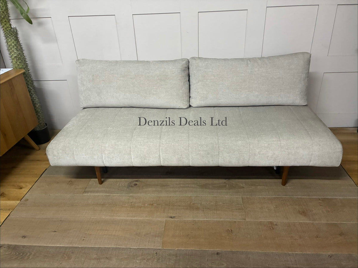 A minimalist Innovation Living Ripple two-seater sofa bed upholstered in smooth, neutral Avella Sand 280 fabric. The sofa features a clean, subdued modern design with tight cushioning, sleek wooden legs, and a sturdy metal frame.