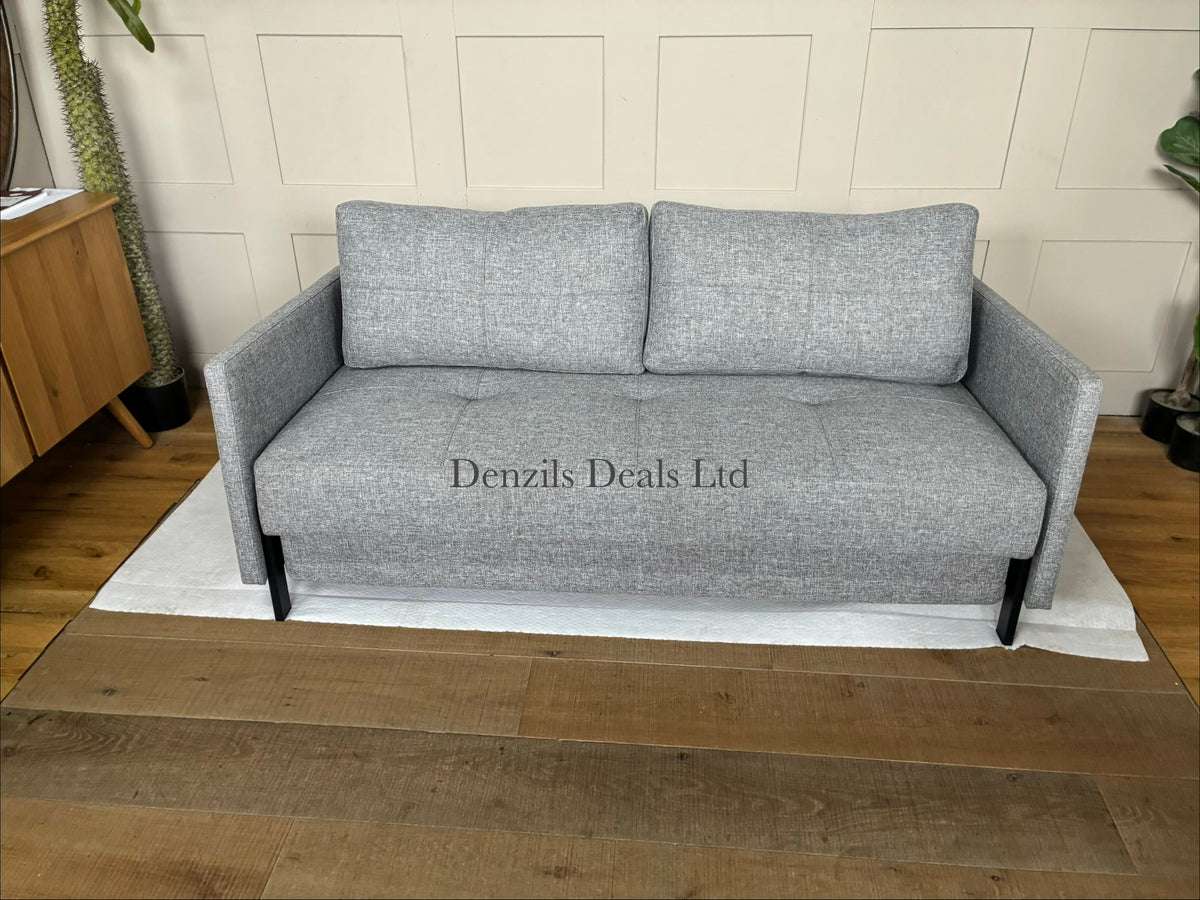 A modern Innovation Living Cubed 160 Sofa Bed upholstered in textured Twist Granite grey fabric, featuring a minimalist armless design supported by slim black metal legs.