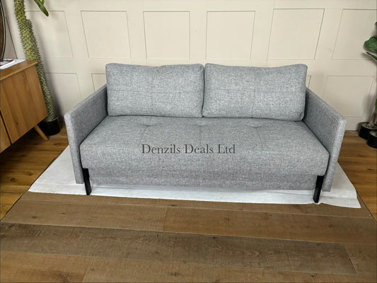 A modern Innovation Living Cubed 160 Sofa Bed upholstered in textured Twist Granite grey fabric, featuring a minimalist armless design supported by slim black metal legs.