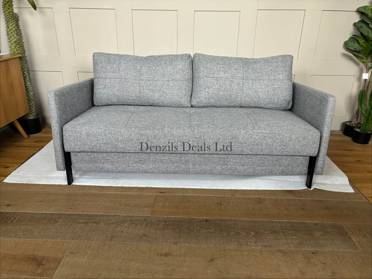 A modern Innovation Living Cubed 160 Sofa Bed upholstered in textured Twist Granite grey fabric, featuring a minimalist armless design supported by slim black metal legs.
