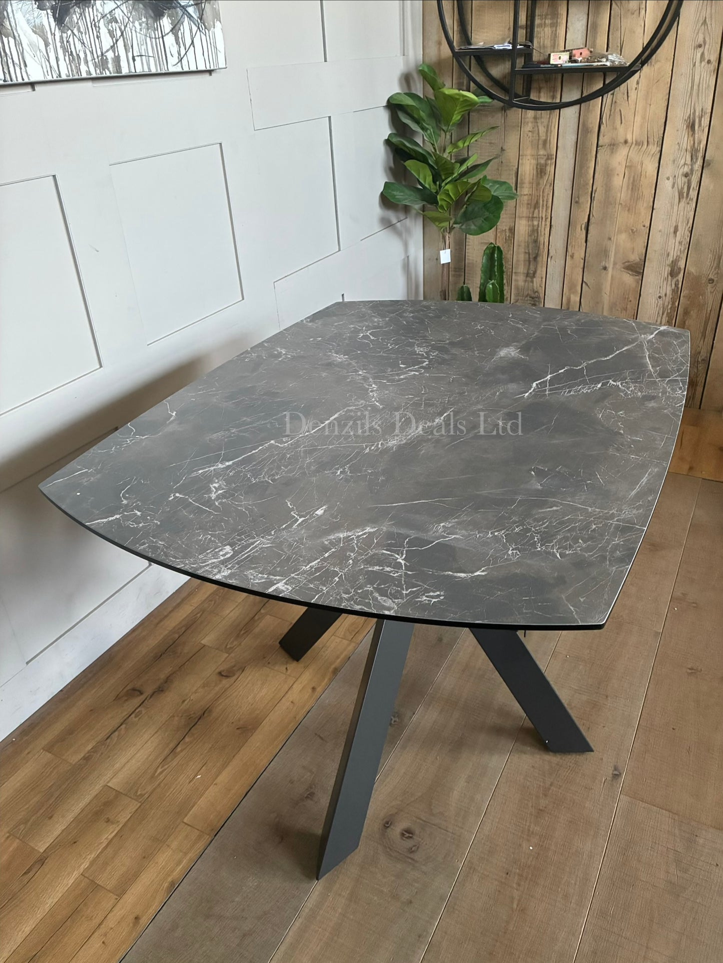 A modern rectangular extending dining table featuring a sleek printed glass top with an HPL finish and a smooth twist-to-open central extension mechanism, supported by a contemporary matte metal base."