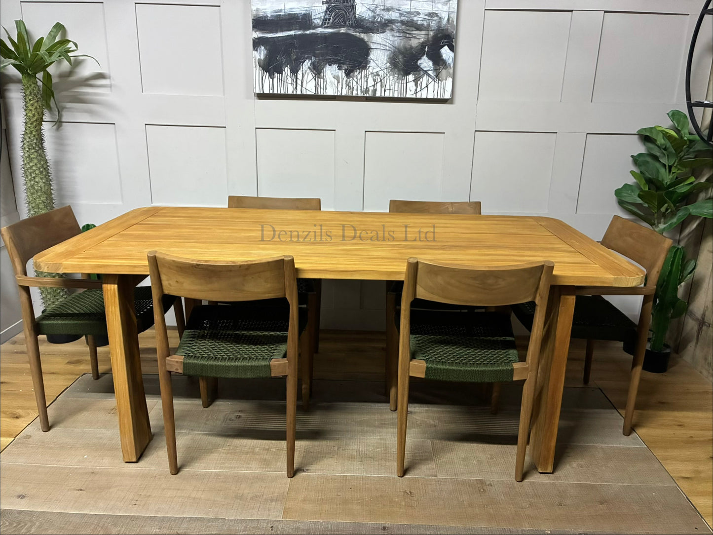 A pair of contemporary Terra garden dining chairs with Scandinavian-inspired teak wood frames and plush, neutral shower-resistant seats."