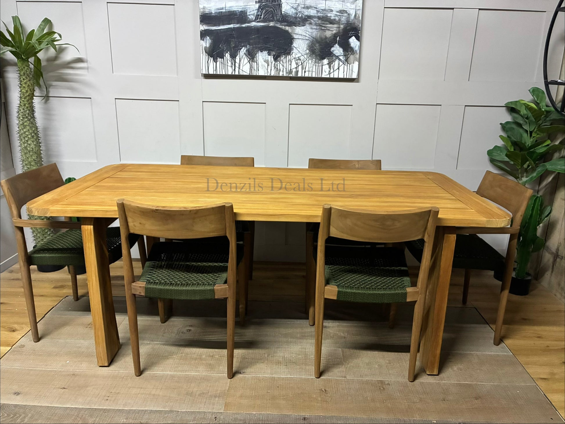 A pair of contemporary Terra garden dining chairs with Scandinavian-inspired teak wood frames and plush, neutral shower-resistant seats."