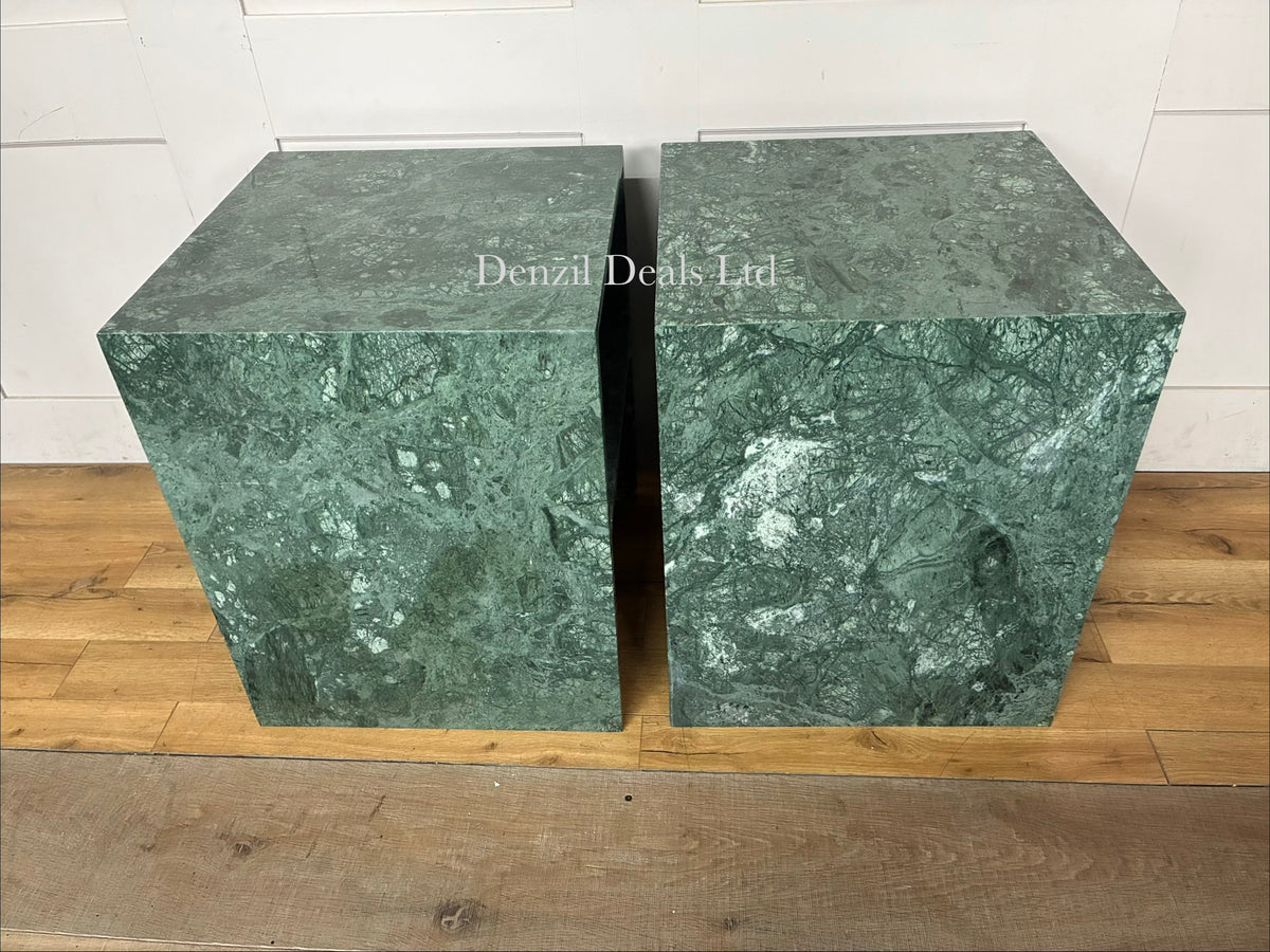 A pair of minimalist green marble Anthropologie Gia side tables with an open-base silhouette, positioned symmetrical to frame a living room setup