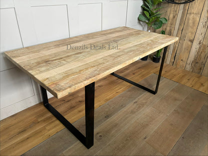 A rectangular 6-seater dining table showcasing a thick, natural mango wood top with prominent organic grain patterns, supported by a strong black industrial-style angular iron base