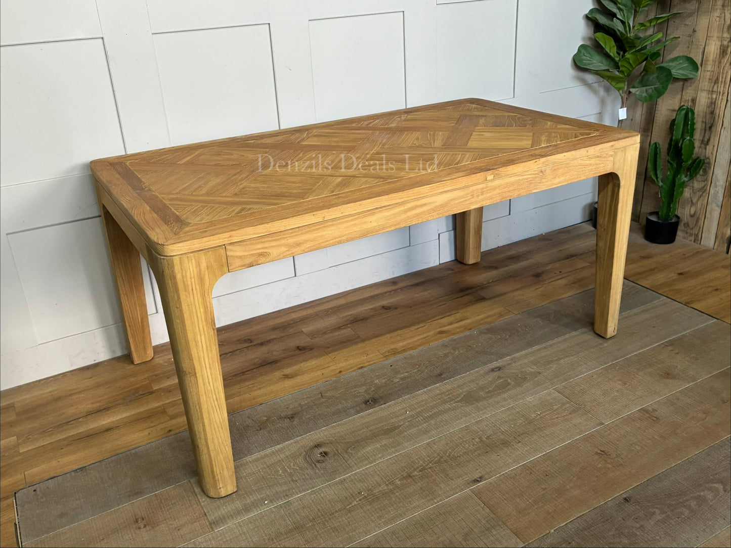"A rectangular dining table crafted from light-toned reclaimed solid teak wood, featuring a subtle marquetry-patterned tabletop and sturdy wooden legs