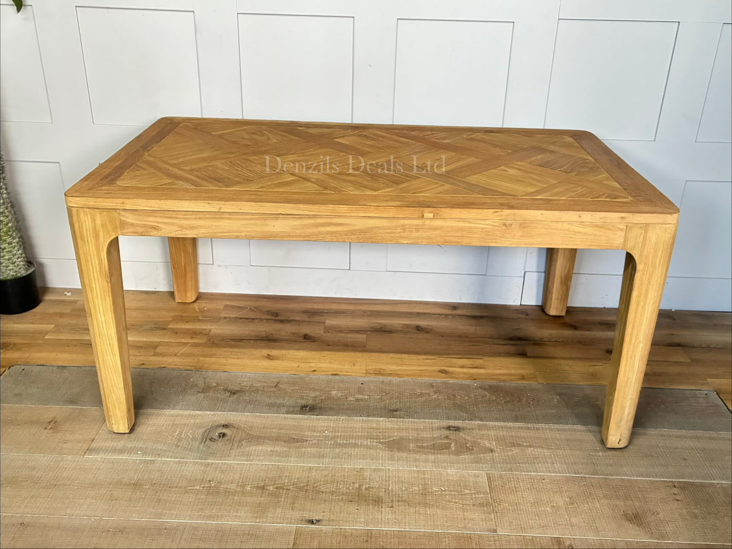 "A rectangular dining table crafted from light-toned reclaimed solid teak wood, featuring a subtle marquetry-patterned tabletop and sturdy wooden legs