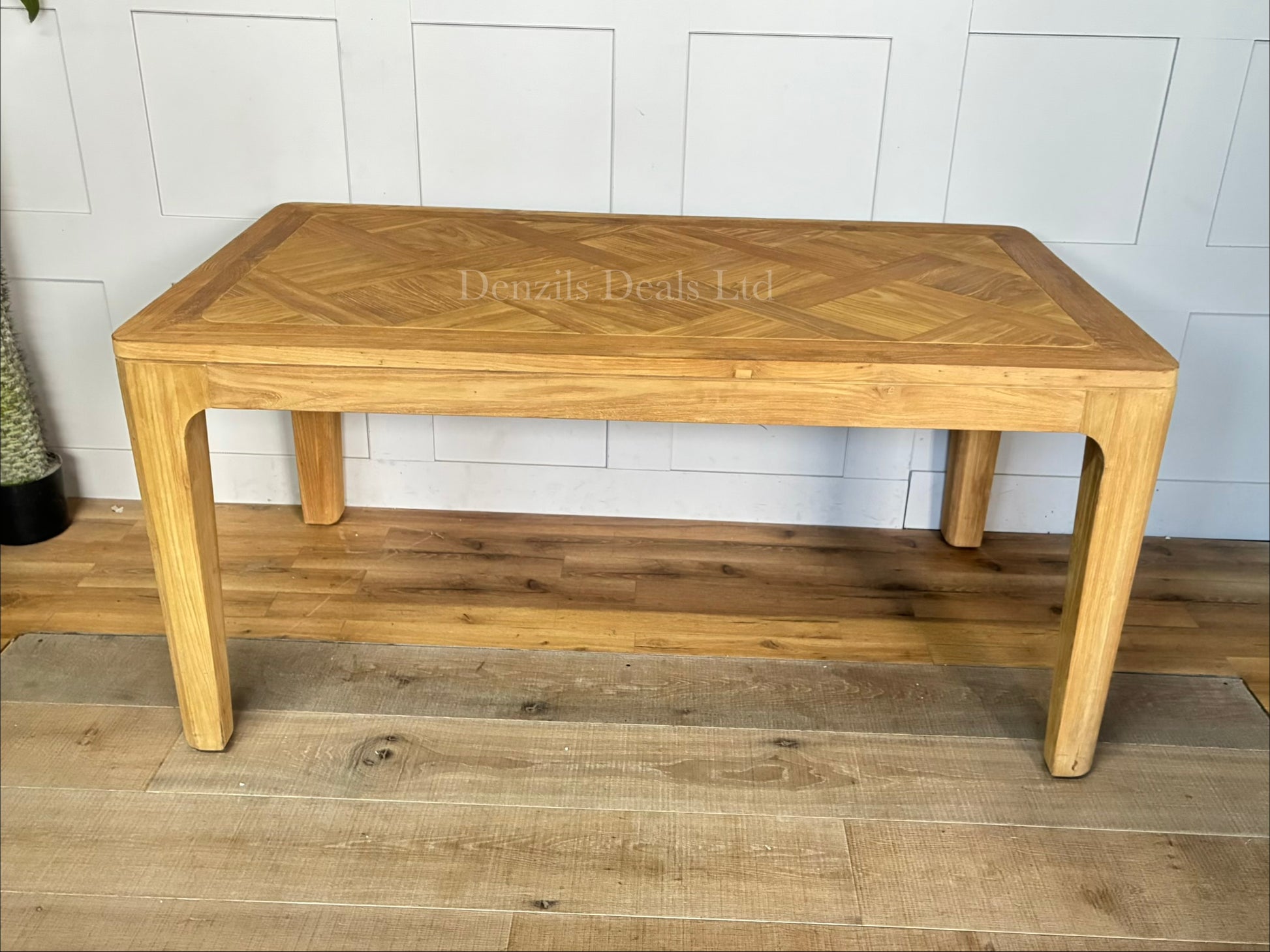 "A rectangular dining table crafted from light-toned reclaimed solid teak wood, featuring a subtle marquetry-patterned tabletop and sturdy wooden legs