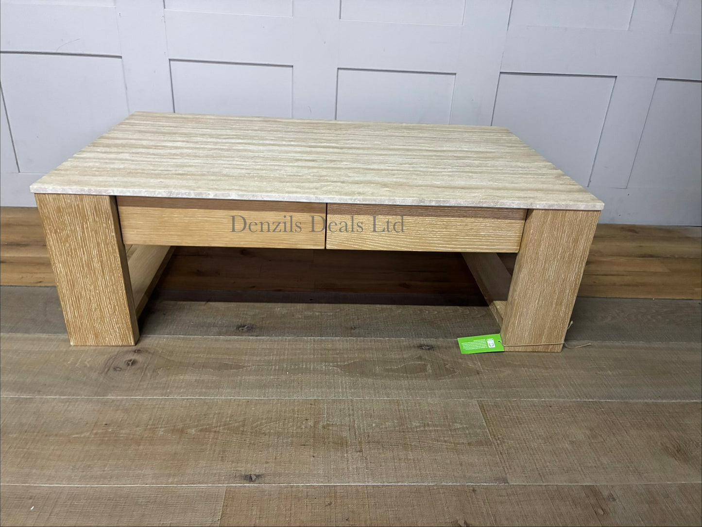 A rectangular low-profile coffee table with a natural cream travertine stone top and a light grey oak wood frame featuring two storage drawers.