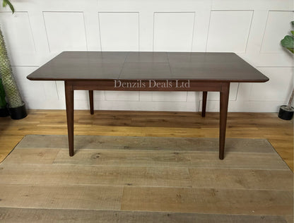 A rectangular mid-century modern dark walnut dining table from the Fishe & Lilly Norway collection, showcasing a rich wood grain and minimalist legs, styled to comfortably seat 4 to 6 people.
