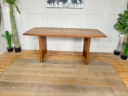 A rectangular natural wood dining table with a herringbone pattern surface and sturdy matching legs, sized for six seats."