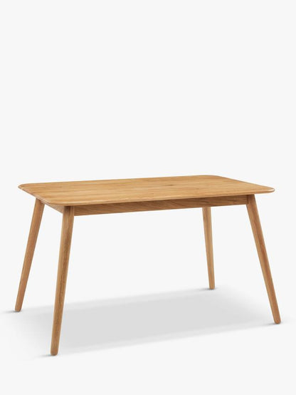A round wooden dining table with a smooth solid oak top finished in a light bianco oil, supported by simple wooden legs
