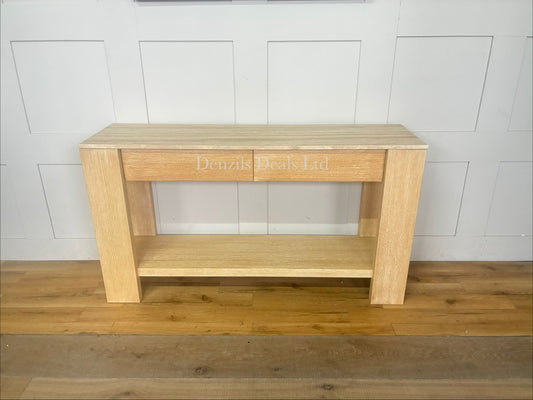 A rustic-modern console table featuring a natural travertine stone top with unique veining, a fog-finished wood base with two storage drawers, and a lower fixed open shelf