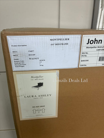 A stately, French-inspired double bed frame from the Laura Ashley Montpellier collection. The bed features a prominent, high arched headboard inset with a light-coloured woven rattan panel that contrasts softly against a dark walnut-stained solid wood frame. The design includes elegant curved legs, profiled side rails, and a clean, low-profile footboard. The mattress area is empty, revealing a supportive solid wood slat base.
