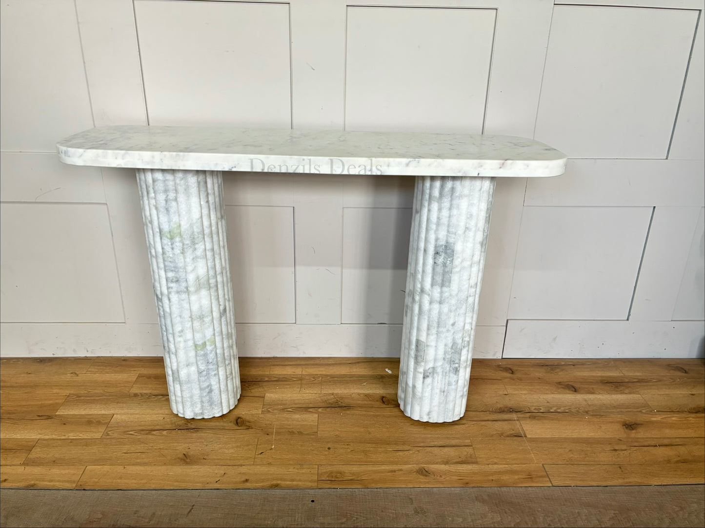 A stately rectangular Anthropologie Kanta console table crafted entirely from pure off-white marble, featuring a smooth top and heavily textured, fluted block legs.