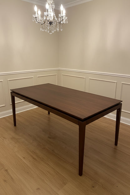 A rectangular walnut wood extending dining table by AM.PM, shown in a contemporary style.