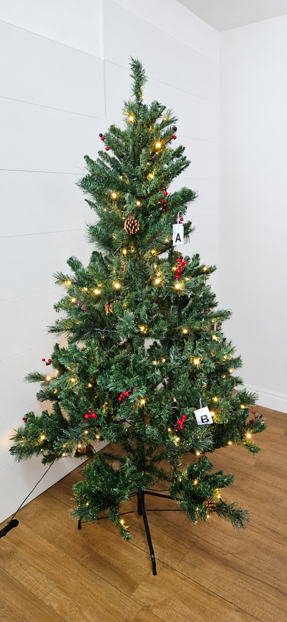 An M&S six-foot green pine-style artificial Christmas tree. The tree features realistic green needles decorated with clusters of bright red berries and natural pine cones, pre-lit with 200 warm white LED lights that emit a soft holiday glow