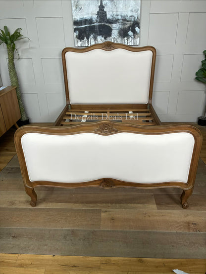 An antique French style wooden bed frame crafted from natural solid Mindy wood, featuring a light whitewash finish, ornate hand-carved detailing, a curved headboard, and a slatted base