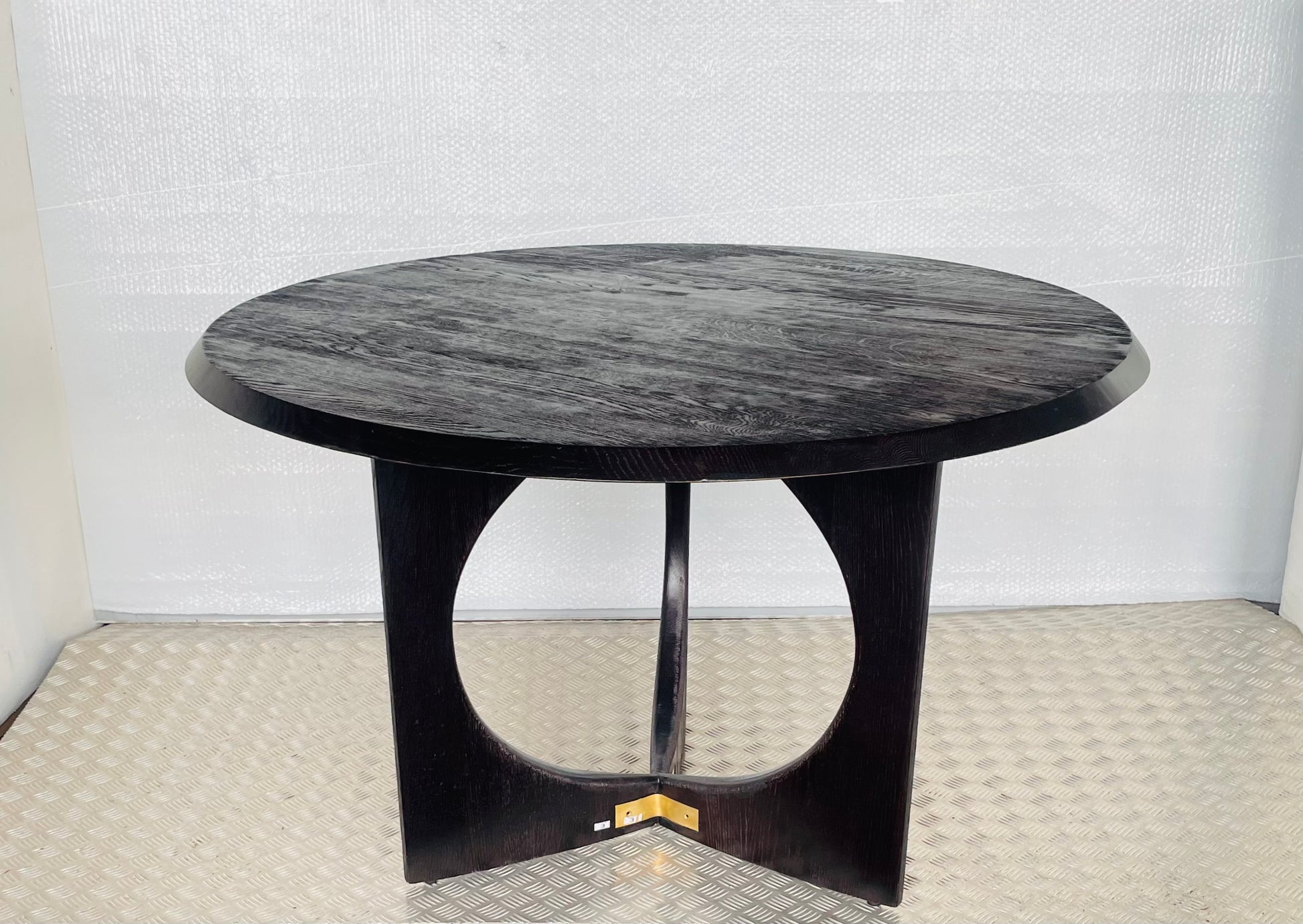 Anthropologie Iris 4- seater Dining Table in light oak with a reeded wood base and clean round tabletop in a bright, modern dining room."