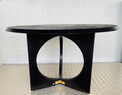 Anthropologie Iris 4 seater Dining Table in light oak with a reeded wood base and clean round tabletop in a bright, modern dining room."