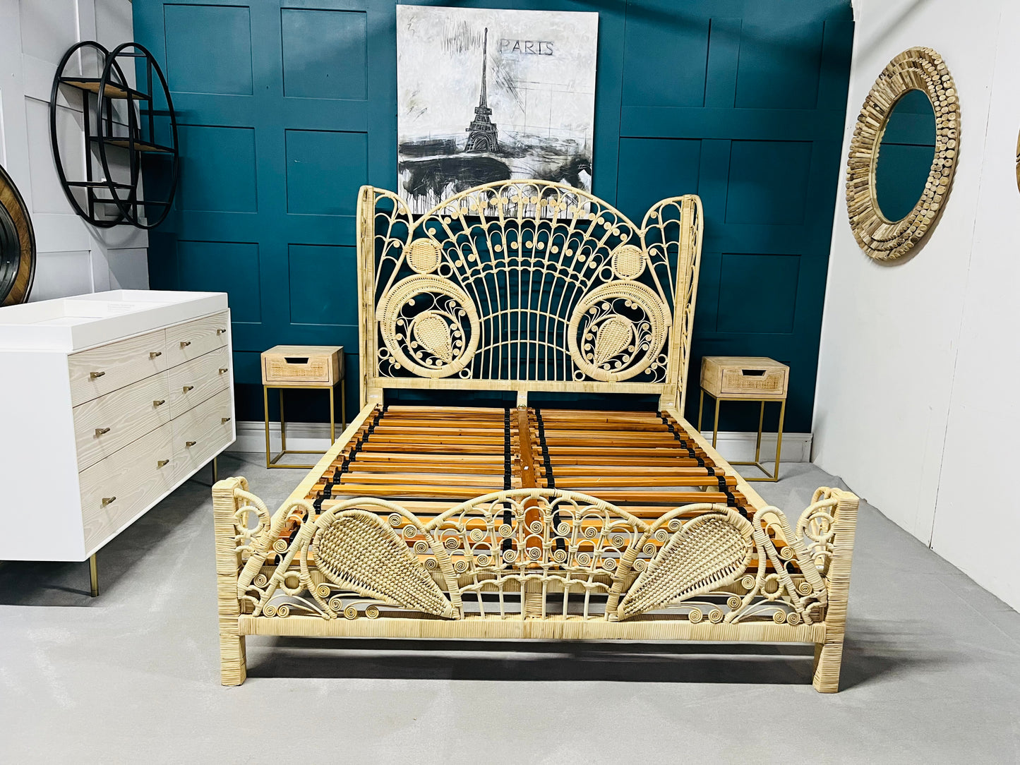 King size Kinsella rattan bed with a natural finish, featuring a high, fan-shaped headboard with intricate feminine filigree weaving and a powder-coated steel frame