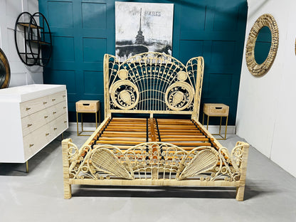 King size Kinsella rattan bed with a natural finish, featuring a high, fan-shaped headboard with intricate feminine filigree weaving and a powder-coated steel frame