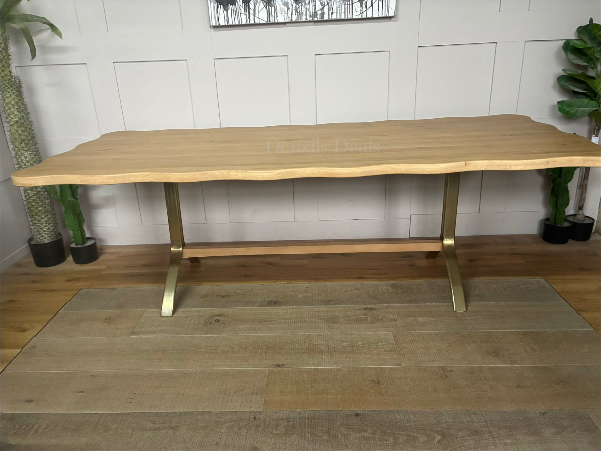 Anthropologie Caldwell Rectangular Oak Dining Table styled in a bright dining room with matching wooden chairs and a decorative vase setup. With alternative legs