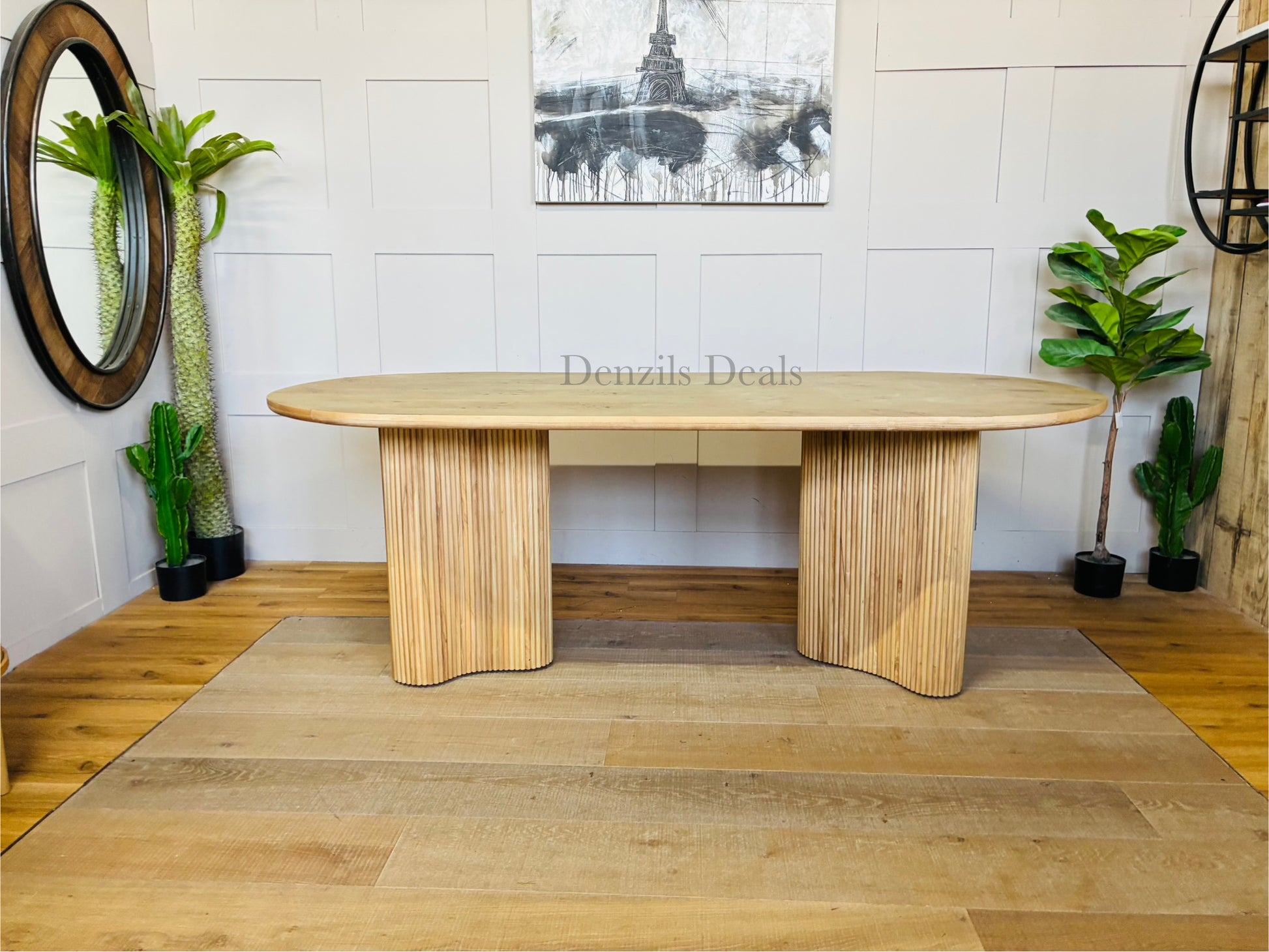 Anthropologie Scout dining table in light ash wood, featuring a decorative veneer top and a chunky, fluted base."
