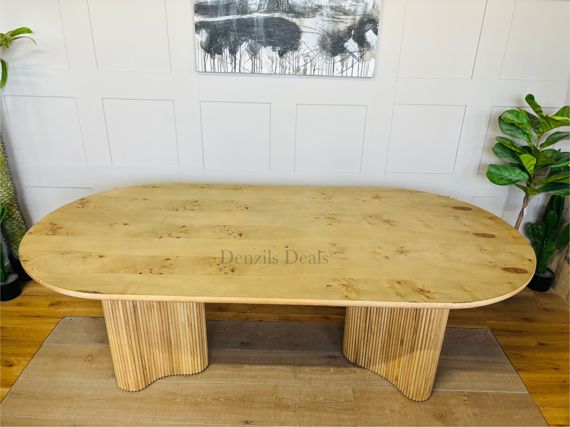Interior shot of the Anthropologie Scout dining table, crafted from blond ash wood with an organic woodgrain veneer top and whimsical, curved fluted legs